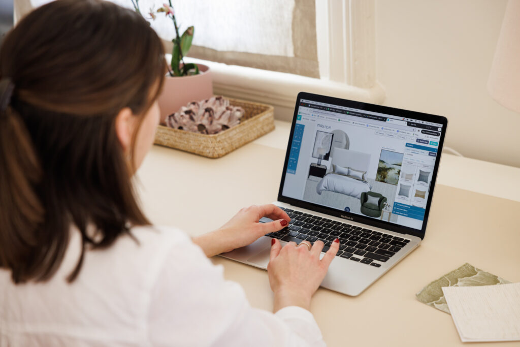 Emma Blomfield sat at her desk, surrounded by a potted plant, basket, and fabric samples, envisioning how the online furniture choices could transform her office space for new team recruitment.